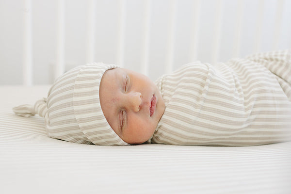 Taupe stripe ribbed bamboo stretch swaddle for babies, perfect for cozy sleep and comfort. Angle 3 view.