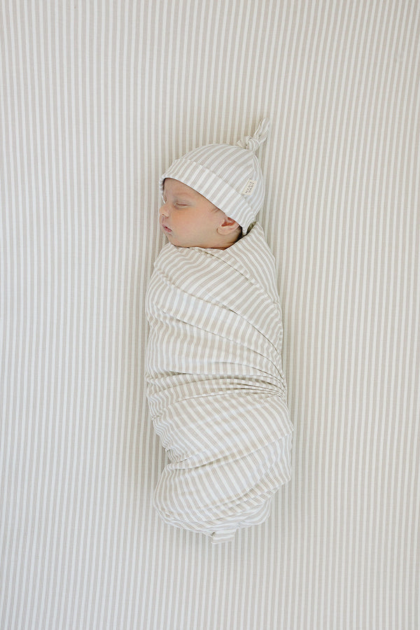 Taupe stripe ribbed bamboo stretch swaddle for babies, perfect for cozy sleep and comfort.