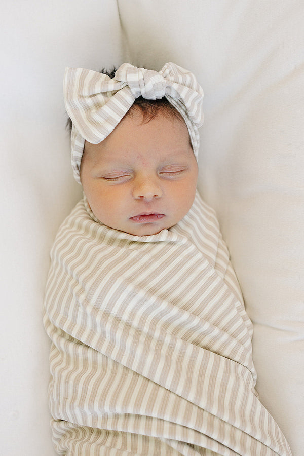 Taupe stripe ribbed bamboo stretch swaddle for babies, perfect for cozy sleep and comfort.