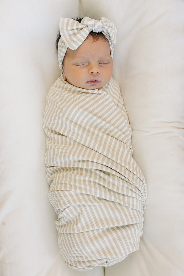 Taupe stripe ribbed bamboo stretch swaddle for babies, perfect for cozy sleep and comfort. Angle 2 view.