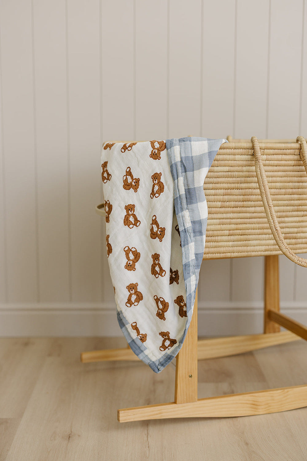 Dusty blue gingham teddy bear muslin quilt for babies, perfect for swaddling and cozy comfort.