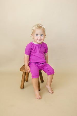 Solid ribbed bamboo shorty romper in various colors, angle 2 view, perfect for babies.