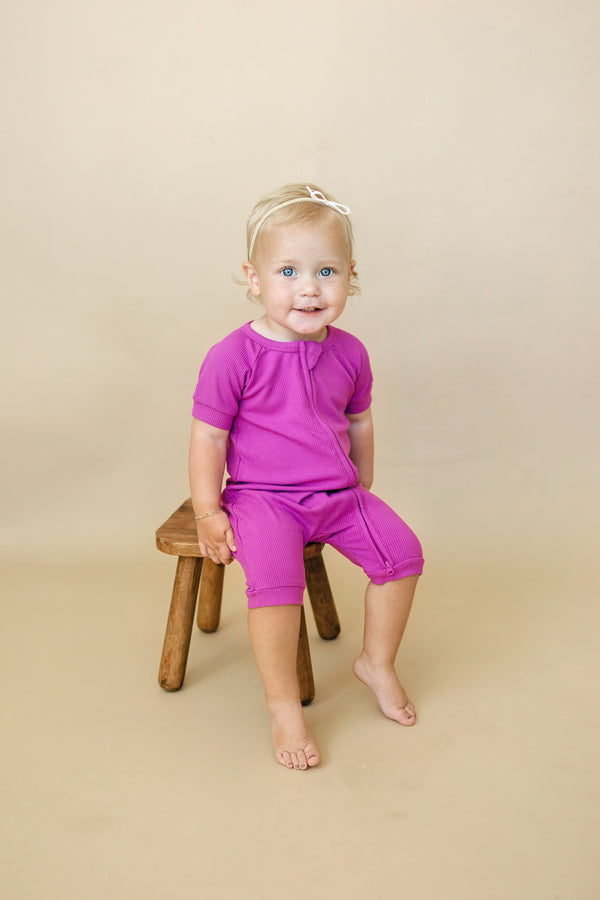 Solid ribbed bamboo shorty romper in various colors, angle 2 view, perfect for babies.