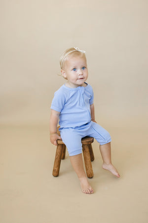 Solid ribbed bamboo shorty romper for babies, available in multiple colors. Perfect for comfort and style.