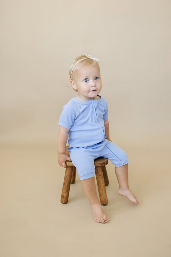Solid ribbed bamboo shorty romper for babies, available in multiple colors. Perfect for comfort and style.