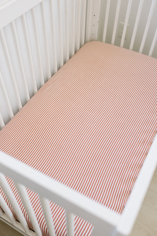 Pink stripes muslin crib sheet for baby bedding, showcasing a soft and breathable design from angle 2.