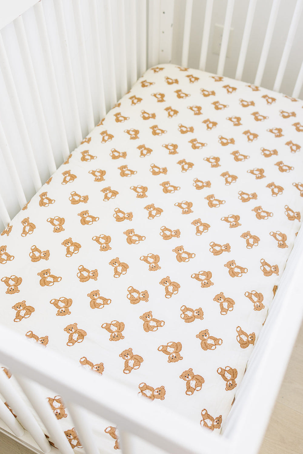 Teddy bear muslin crib sheet for cozy and stylish baby bedding and sleep.