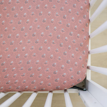 Vintage pink floral muslin crib sheet for stylish and comfortable baby bedding. Perfect for enhancing nursery decor.