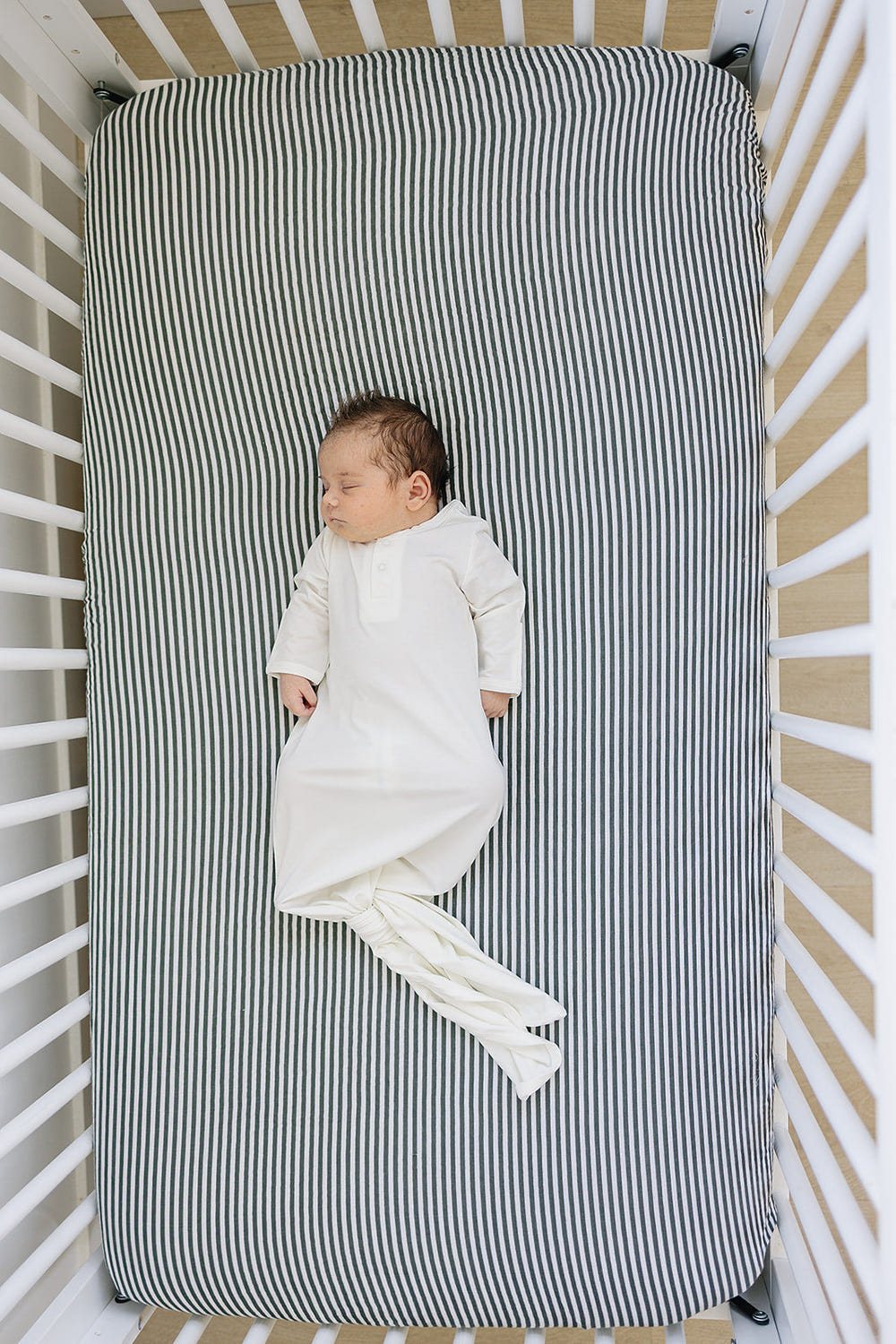 White Bamboo Knot Gown for babies, soft and breathable, perfect for swaddling and comfort during sleep.