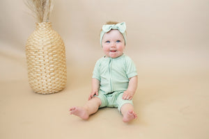 Solid ribbed bamboo shorty romper in various colors, angle 3 view, perfect for babies.