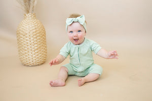 Solid ribbed bamboo shorty romper in various colors, displayed at angle 4. Ideal for stylish baby outfits.