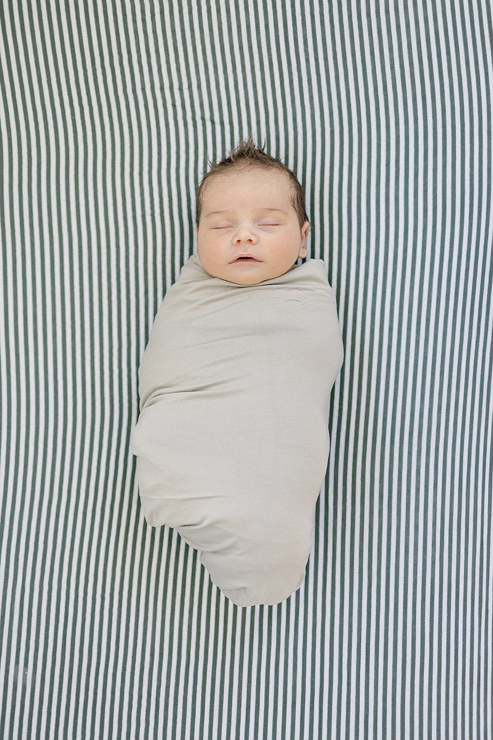 Green Stripes Muslin Crib Sheet for stylish and comfortable baby bedding. Perfect for any nursery decor.