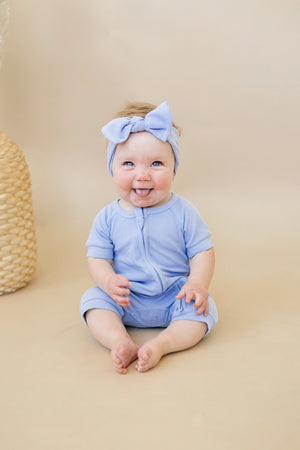Solid ribbed bamboo shorty romper in various colors, displayed at angle 6. Perfect for stylish baby outfits.