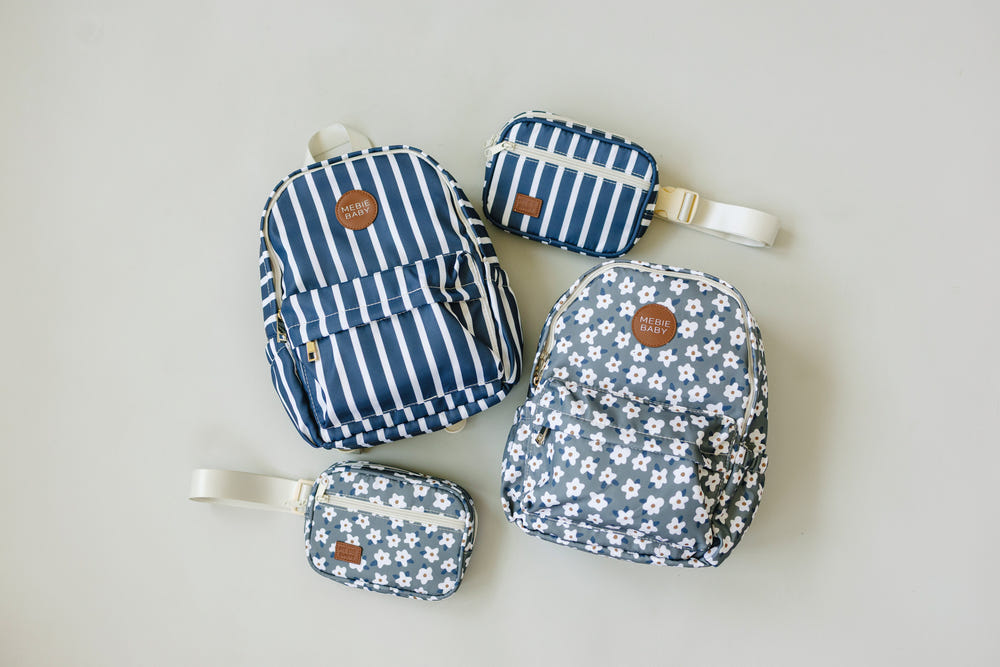 Green floral mini backpack for babies, perfect accessory for outings and seasonal wear.