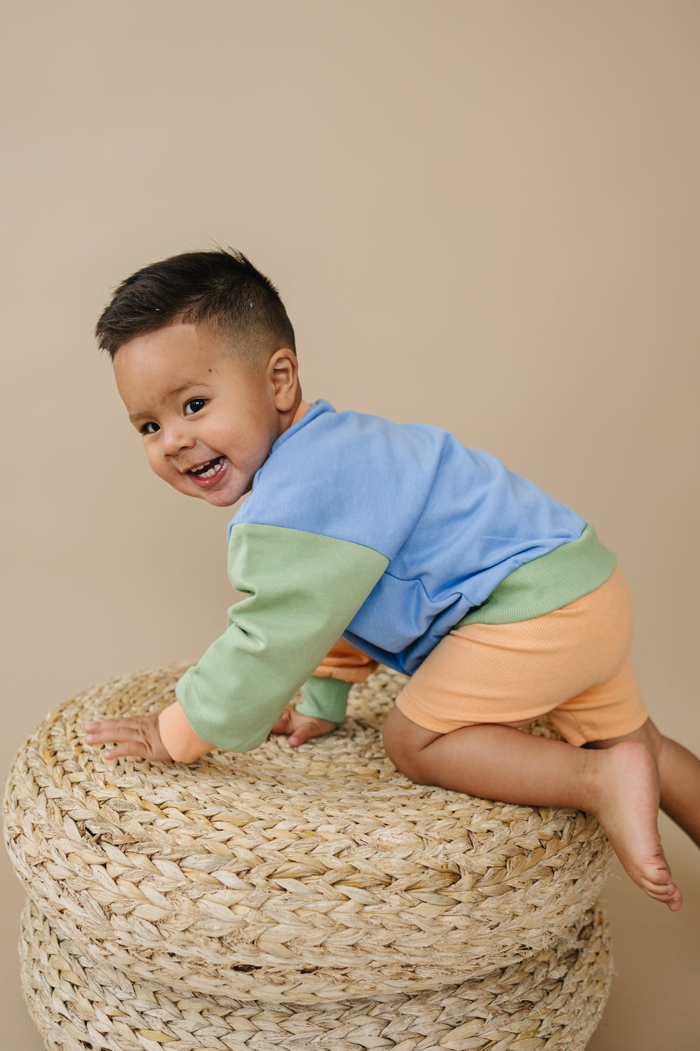 Orange ribbed bike shorts for babies, perfect for comfort and style during playtime.