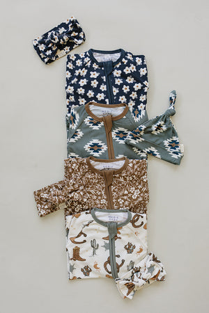 Brown floral ribbed bamboo zipper footie pajamas for babies, showcasing a stylish design from an angled view.