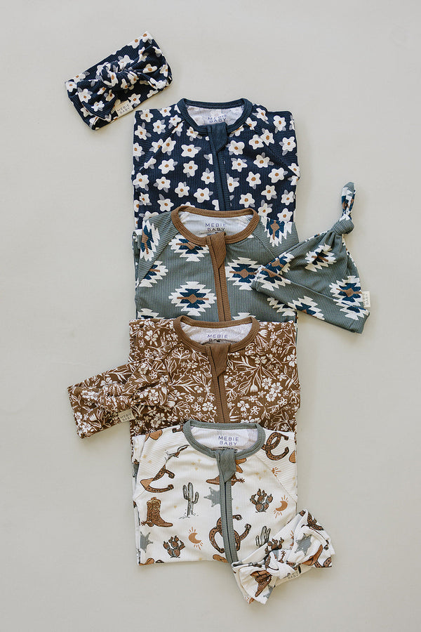 Brown floral ribbed bamboo zipper footie pajamas for babies, showcasing a stylish design from an angled view.