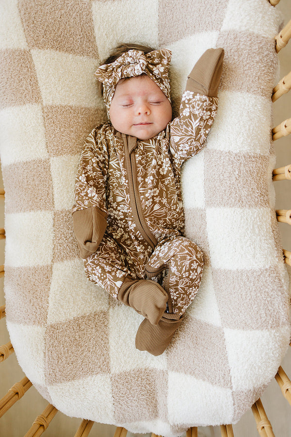 Brown floral ribbed bamboo zipper footie pajamas for babies, showcasing a stylish design from angle 3.