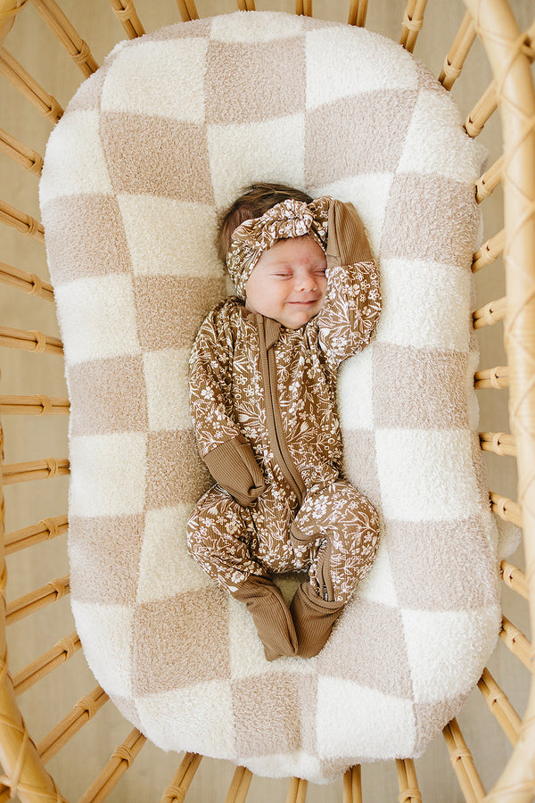 Brown floral ribbed bamboo zipper footie pajamas for babies, shown from angle 2. Perfect for comfort and style.