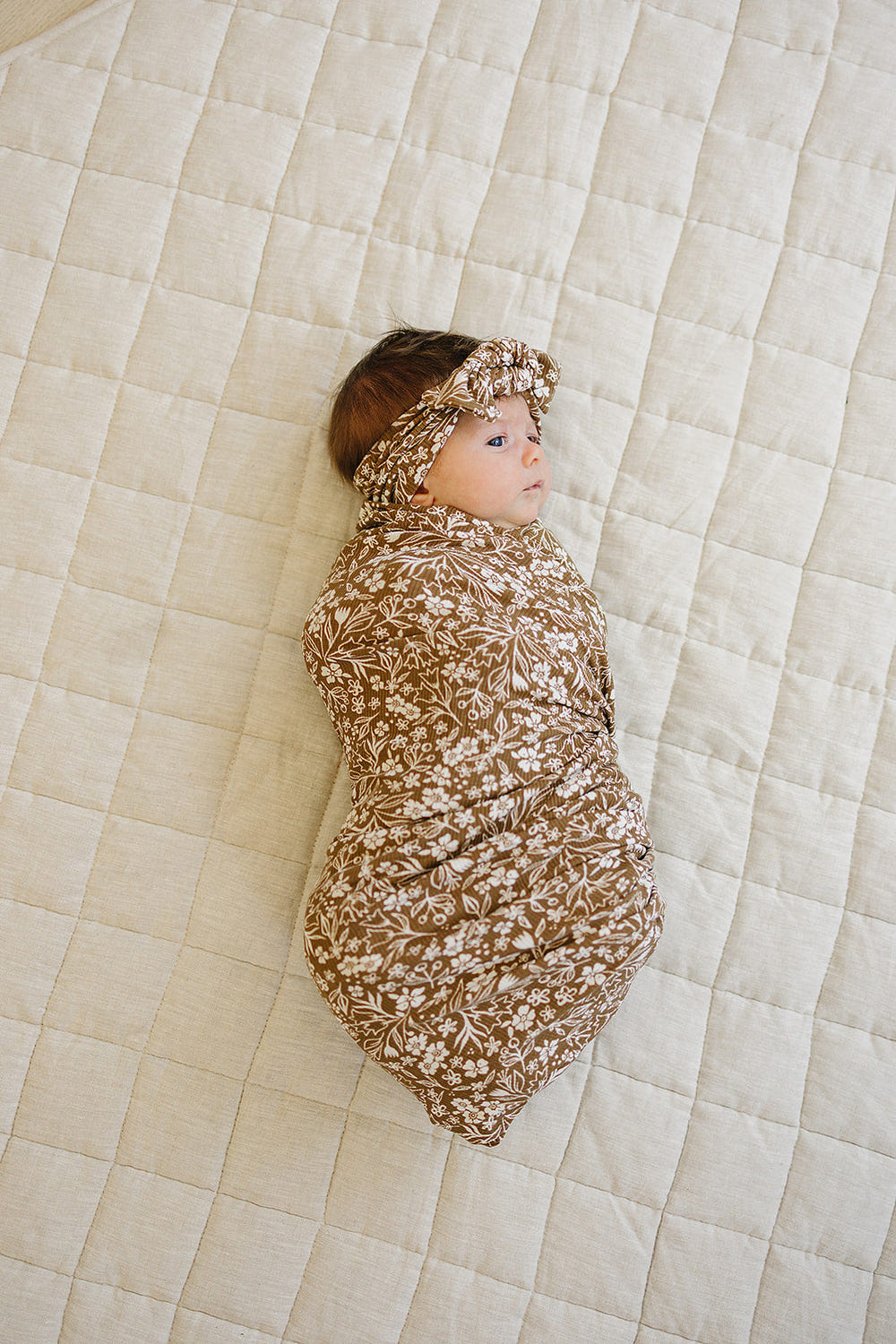 Brown floral ribbed bamboo stretch swaddle for babies, soft and breathable, perfect for cozy swaddling and comfort.