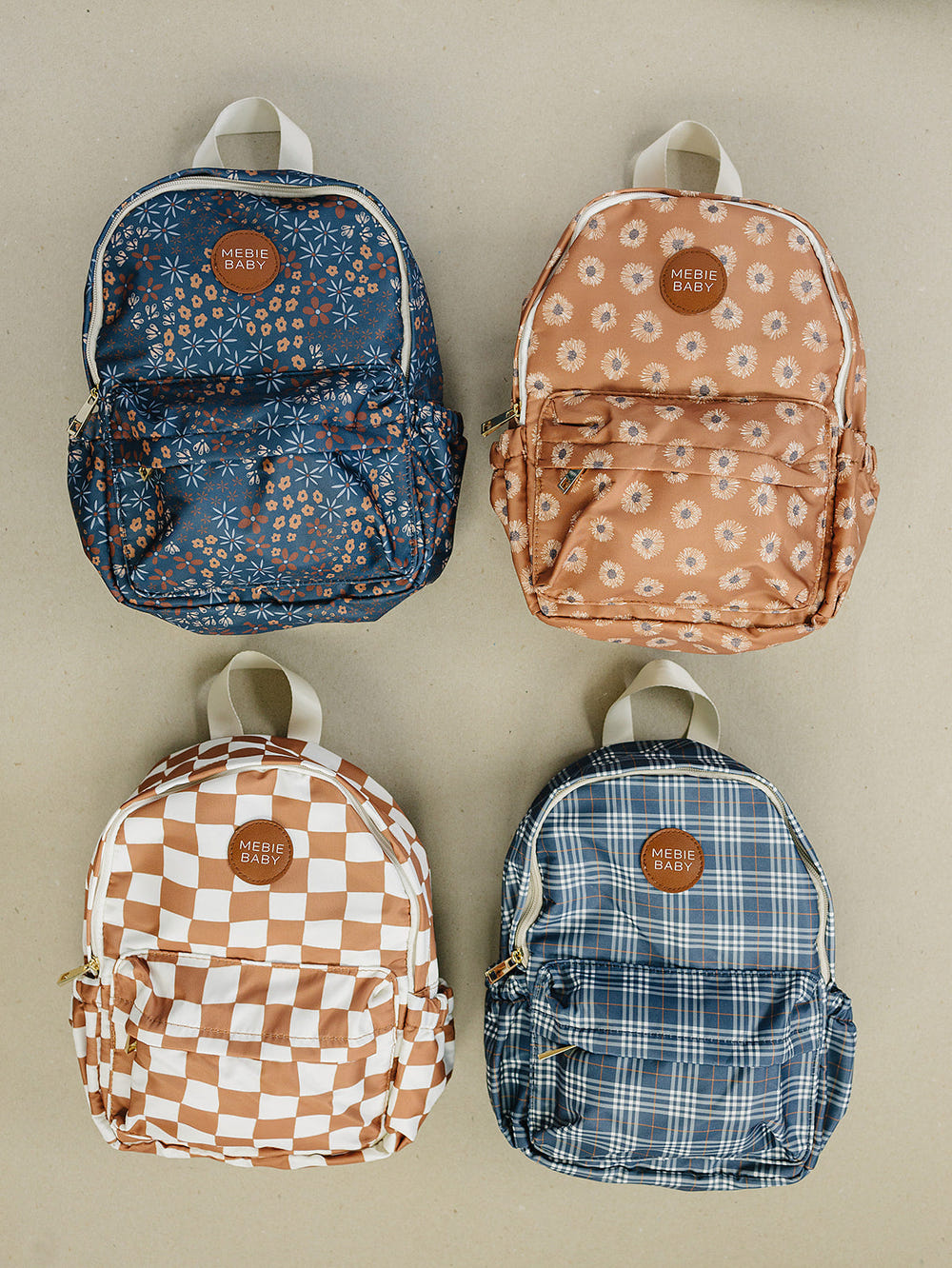 Navy floral mini backpack for babies, perfect for stylish outings and everyday use.