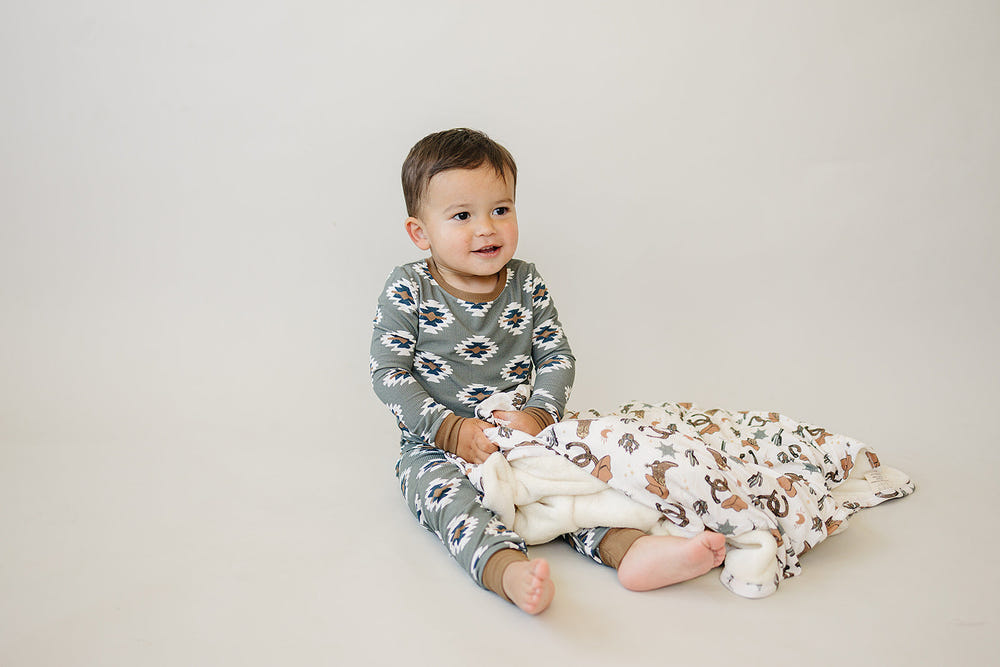 Outlaw Cowboy Bamboo Fleece Quilt - Cozy wall art for nursery decor, featuring a charming cowboy design.