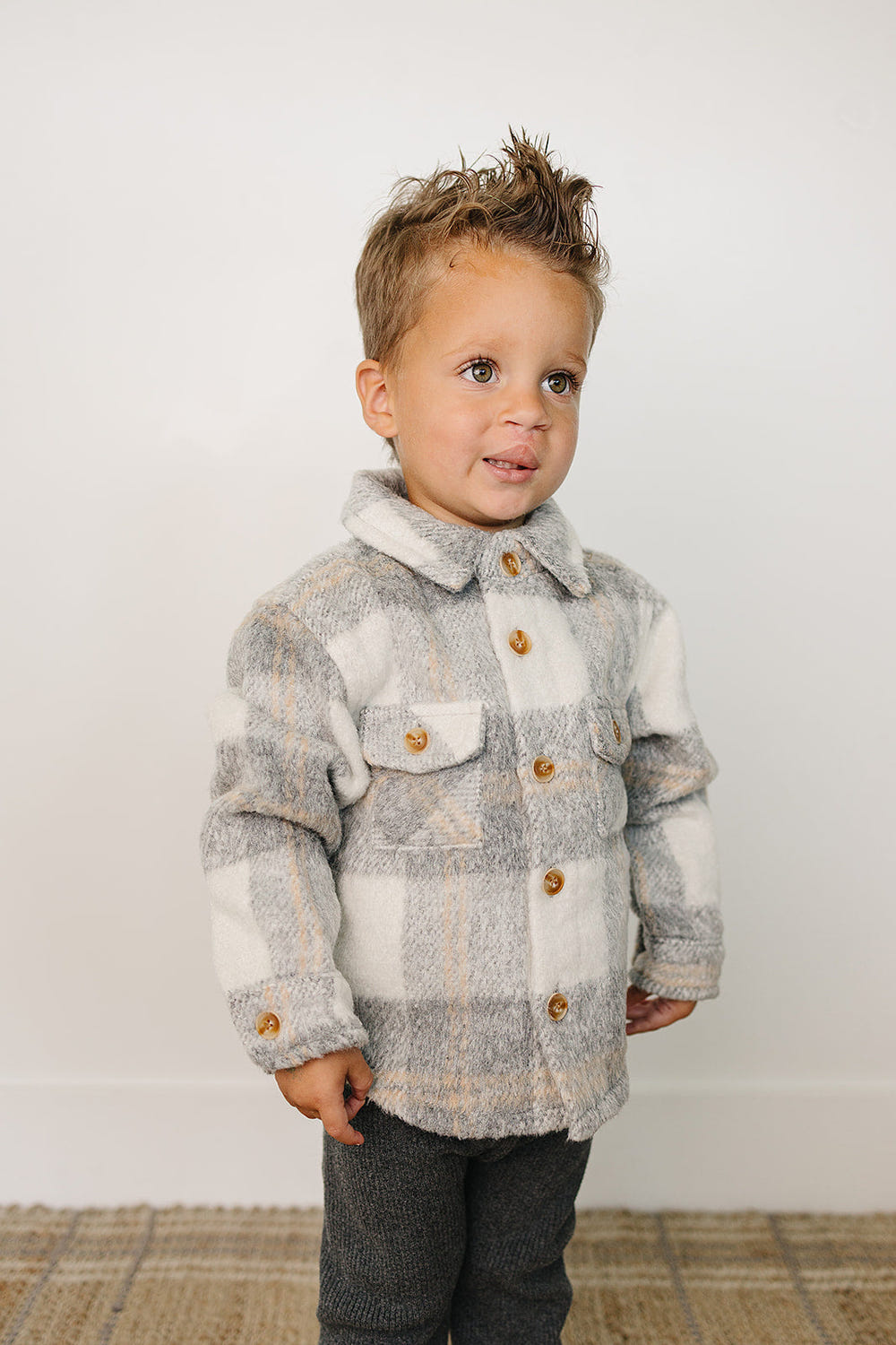 Grey plaid shacket for babies, perfect for stylish layering in cooler weather.