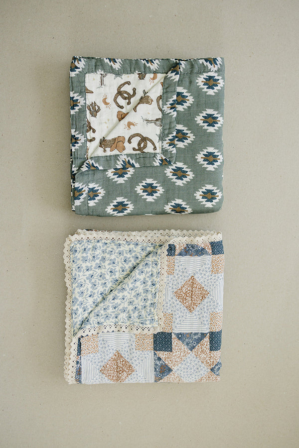 Patchwork print and blue blossom lace muslin quilt for babies, perfect for bedding and sleep. Angle view 6.