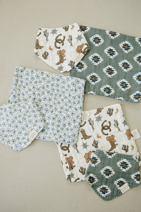 Outlaw Cowboy Classic Muslin Bib for babies, stylish and soft, angle view showcasing design and fabric texture.