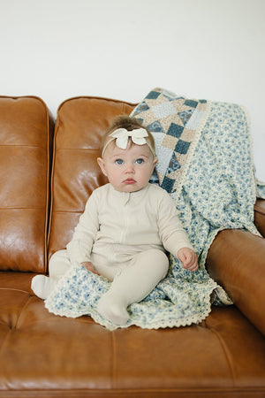 Patchwork print and blue blossom lace muslin quilt for babies, perfect for bedding and sleep. Angle 3 view.