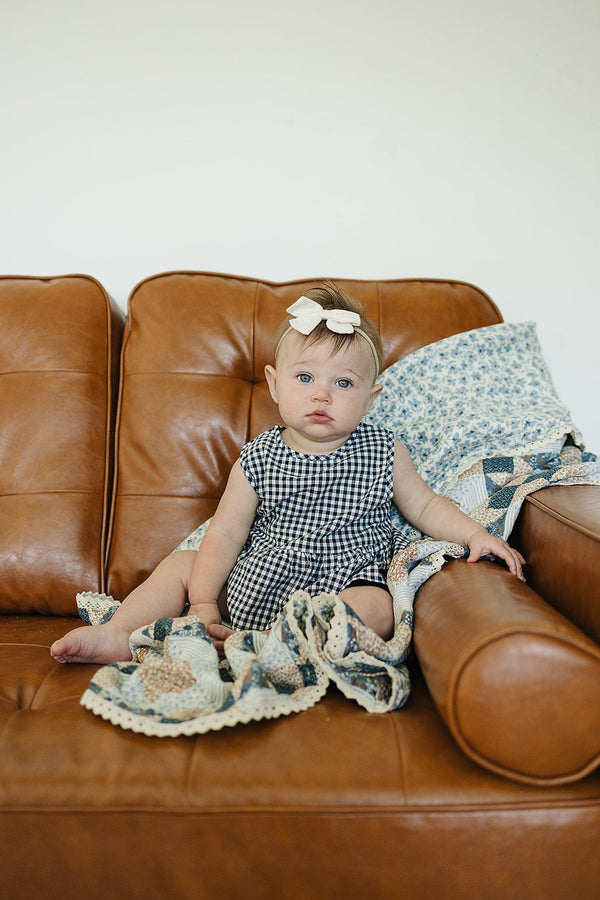 Patchwork print and blue blossom lace muslin quilt for babies, perfect for bedding and sleep. Angle view 5.