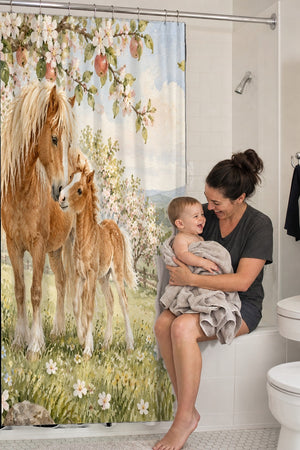 Mom holding her baby on the tub edge next to the Pony Orchard Farm shower curtain