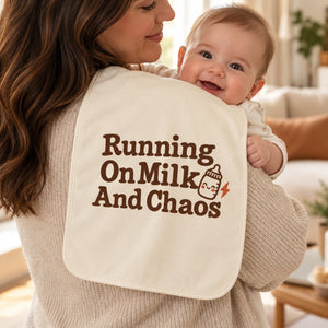 Running On Milk And Chaos burp cloth in cream, styled photo 1
