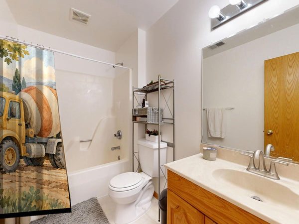 Cement Mixer shower curtain on a tub shower combo in an American family bathroom