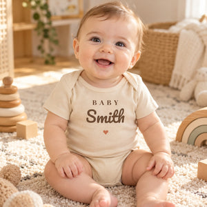 Baby wearing the Baby Surname baby bodysuit