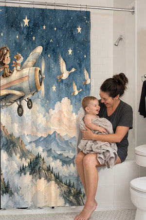 Mom holding her baby on the tub edge next to the Moonlit Flight shower curtain