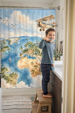 Child brushing teeth in a family bathroom with the World Explorer shower curtain