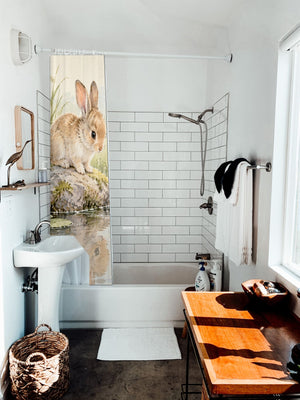 Quiet Garden Pond Bunny shower curtain hanging on the rod over a white bathtub