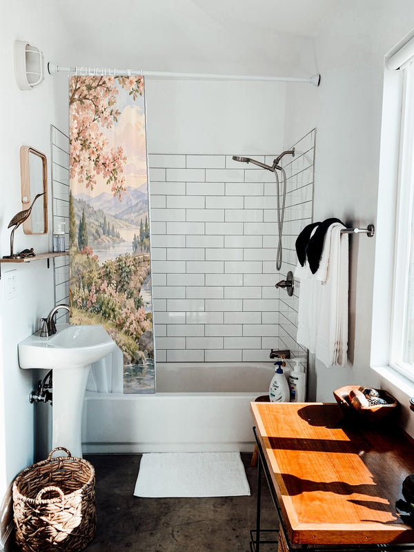 Woodland Castle Fairy Tale shower curtain hanging on the rod over a white bathtub