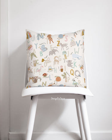 Artisan baby pillows featuring colorful alphabet designs for nursery decor. Perfect for comfort and style.