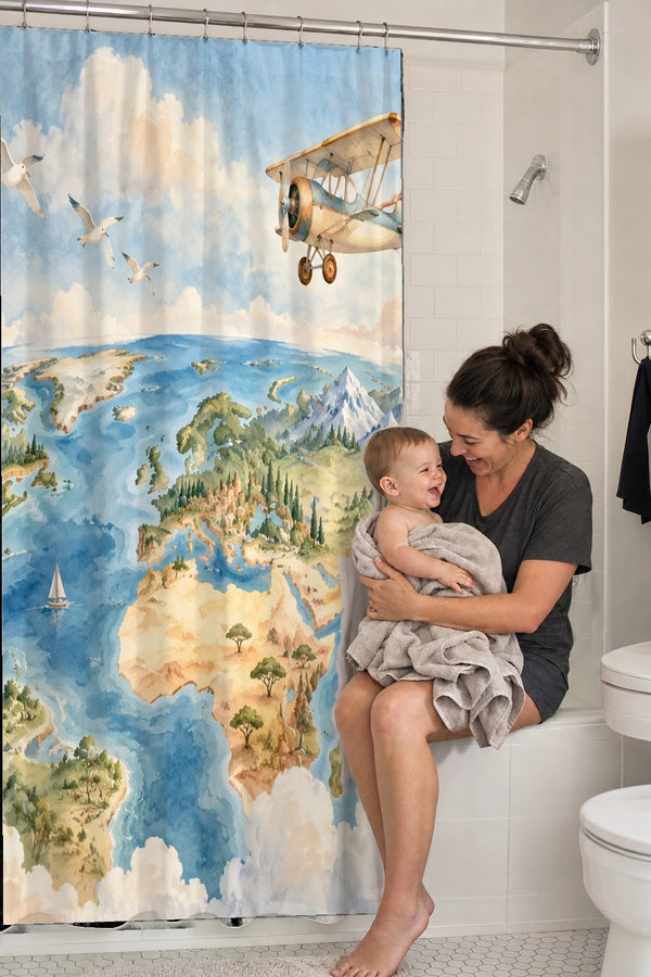 Mom holding her baby on the tub edge next to the World Explorer shower curtain