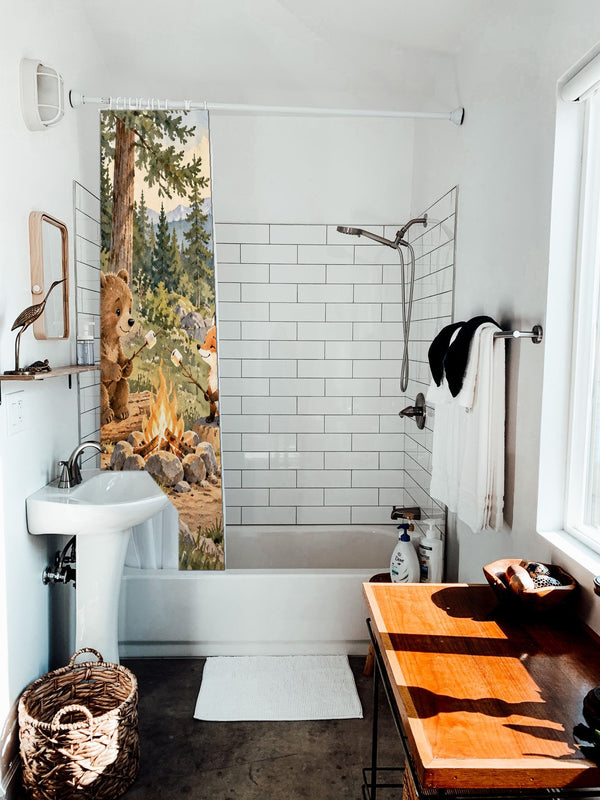 Bear and Fox Campfire Camping shower curtain hanging on the rod over a white bathtub