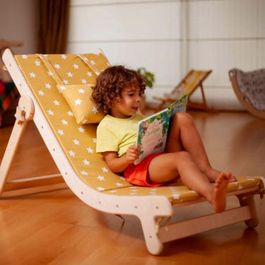 Adjustable lounge chair with comfy pad for kids, perfect for relaxation and playtime.