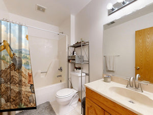 Construction Site shower curtain on a tub shower combo in an American family bathroom