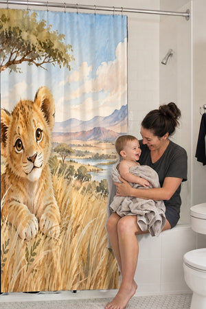 Mom holding her baby on the tub edge next to the Lion Cub Safari shower curtain