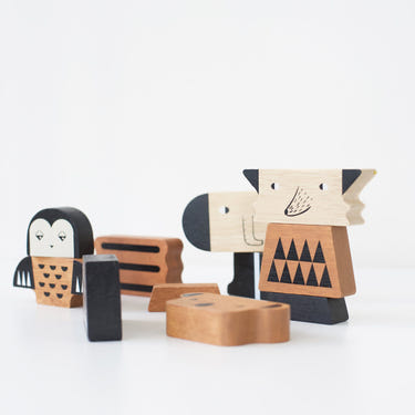Colorful wooden animal building tower toy for babies, promoting creativity and motor skills development.