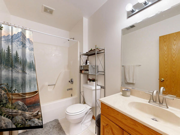 Canoe Lake Camping shower curtain on a tub shower combo in an American family bathroom