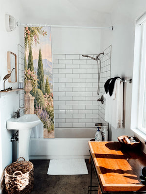 Castle Garden Fairy Tale shower curtain hanging on the rod over a white bathtub