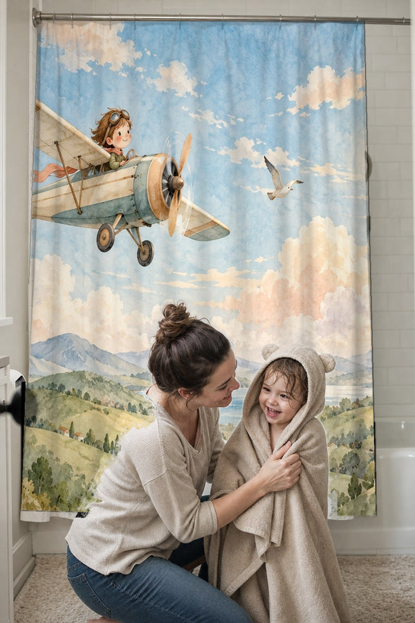 Mom drying her toddler in a hooded towel in front of the Vintage Airplane shower curtain
