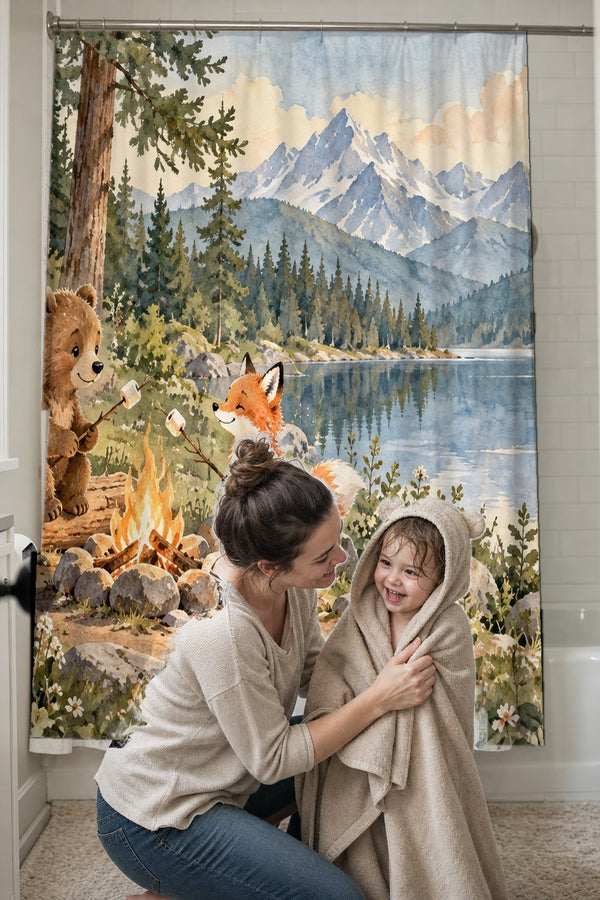 Mom drying her toddler in a hooded towel in front of the Bear and Fox Campfire Camping shower curtain